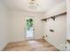 Bright laundry room with wood floors, exit to deck, overhead lighting, and a wall shelf at 200 Kimrod Ln, Charlotte, NC 28270