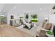 Bright living room featuring modern decor, a large window with a view, and stylish neutral furniture at 200 Kimrod Ln, Charlotte, NC 28270