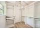 Walk-in closet with custom shelving, drawers and storage solutions, illuminated by modern lighting at 200 Kimrod Ln, Charlotte, NC 28270
