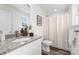 Modern bathroom featuring granite counters, white cabinetry and decorative shower curtain at 2123 Gemway Dr, Charlotte, NC 28216