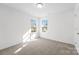 Bright, carpeted bedroom featuring two large windows and white walls at 2123 Gemway Dr, Charlotte, NC 28216