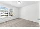 Bright, carpeted bedroom with a large window providing ample natural light at 2123 Gemway Dr, Charlotte, NC 28216