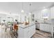 Open kitchen and living area with stainless steel appliances, island, and hardwood floors at 2123 Gemway Dr, Charlotte, NC 28216