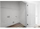Functional laundry room with essential hookups, shelf, ample space, and neutral finishes with wood-look floors at 2123 Gemway Dr, Charlotte, NC 28216