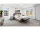 Comfortable main bedroom featuring a queen bed, large windows, plush carpet, and neutral décor at 2123 Gemway Dr, Charlotte, NC 28216