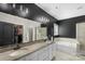 Modern bathroom featuring a double sink vanity, walk-in shower, and a soaking tub for ultimate relaxation at 2214 Laurens Dr, Concord, NC 28027