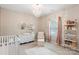 Adorable Bedroom with crib, chandelier, decorative shelves, and dresser at 2214 Laurens Dr, Concord, NC 28027