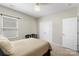 Cozy bedroom with a neutral palette, a bed, a bench, and ample natural light from the window at 2214 Laurens Dr, Concord, NC 28027