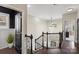 Staircase in the foyer with wood floors, iron railing, and a elegant chandelier at 2214 Laurens Dr, Concord, NC 28027