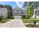 Charming two-story home with a well-manicured lawn, a two car garage and beautiful stone accents at 2214 Laurens Dr, Concord, NC 28027
