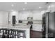 Bright, modern kitchen with stainless steel appliances, granite countertops, and a kitchen island with stools at 2214 Laurens Dr, Concord, NC 28027