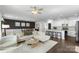 Open-concept living area featuring hardwood floors, lots of windows, modern furniture, and an adjacent kitchen at 2214 Laurens Dr, Concord, NC 28027