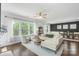 Bright living room with a ceiling fan, hardwood floors, lots of windows, and modern furniture at 2214 Laurens Dr, Concord, NC 28027