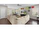 Bright living room with a large sectional sofa, ceiling fan, and work space near window at 2214 Laurens Dr, Concord, NC 28027