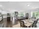 Open concept living room, dining, and kitchen with stainless steel appliances and fireplace at 2214 Laurens Dr, Concord, NC 28027