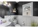 Stylish powder room with white wainscoting, round mirror, and modern fixtures for guest convenience at 2214 Laurens Dr, Concord, NC 28027
