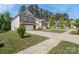 Attractive homes line a street with manicured lawns and tree lined parkways in a vibrant community at 2214 Laurens Dr, Concord, NC 28027