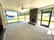 Screened porch with a stone fireplace and ceiling fan, perfect for outdoor relaxation at 2567 Cornelius Nw Pl, Concord, NC 28027