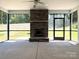 Covered porch with a stone fireplace and ceiling fan, perfect for outdoor relaxation at 2567 Cornelius Nw Pl, Concord, NC 28027