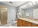 Bathroom features a double vanity, granite countertop, and walk-in shower at 315 Arlington Ave # 1104, Charlotte, NC 28203