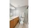 Bathroom features neutral paint, tile flooring, a full mirror, and wood cabinetry with a sink at 315 Arlington Ave # 1104, Charlotte, NC 28203