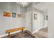 Hallway featuring hardwood floors, bench, and stylish light fixture at 315 Arlington Ave # 1104, Charlotte, NC 28203