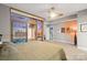 This main bedroom features a ceiling fan, balcony access, and stunning city views at 315 Arlington Ave # 1104, Charlotte, NC 28203