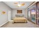 This is a main bedroom with carpet and a ceiling fan and a sliding glass door leading to a balcony at 315 Arlington Ave # 1104, Charlotte, NC 28203