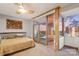 This spacious main bedroom features a ceiling fan and a sliding glass door leading to a balcony at 315 Arlington Ave # 1104, Charlotte, NC 28203