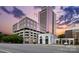 Street view of building featuring modern architecture and nearby shops against a beautiful sky at 315 Arlington Ave # 1104, Charlotte, NC 28203