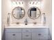 Bright bathroom featuring double sinks, quartz counters, stylish mirrors, and white shiplap walls at 3619 Whitney Way, Terrell, NC 28682