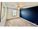 Carpeted bedroom featuring a ceiling fan, blue accent wall, and white shutters at 3619 Whitney Way, Terrell, NC 28682