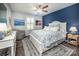 Inviting bedroom with white furniture, blue accent wall, and serene landscape artwork at 3619 Whitney Way, Terrell, NC 28682