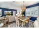 Open concept dining room with elegant chandelier, white shutters, and a view of the cozy living room at 3619 Whitney Way, Terrell, NC 28682