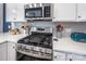 Close-up of a stainless steel gas stove top and microwave that matches the modern kitchen appliances at 3619 Whitney Way, Terrell, NC 28682