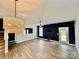 Bright living room featuring sleek floors, modern ceiling fan, shutters and stylish lighting fixture at 3619 Whitney Way, Terrell, NC 28682