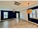 Bright living room featuring sleek floors, modern ceiling fan, shutters and stylish lighting fixture at 3619 Whitney Way, Terrell, NC 28682