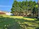 Expansive backyard featuring a lush lawn, mature trees, and a privacy fence perfect for outdoor activities and relaxation at 400 Antlers Ct, Gastonia, NC 28052