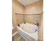 Bathroom features a bathtub with tiled walls and wood-look vinyl flooring at 400 Antlers Ct, Gastonia, NC 28052