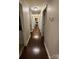 Hallway with dark hardwood flooring and neutral paint leading to various rooms in the home at 400 Antlers Ct, Gastonia, NC 28052