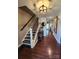Inviting foyer with hardwood floors, staircase, and decorative accents creating a warm and welcoming entrance at 400 Antlers Ct, Gastonia, NC 28052