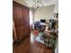 Bright home office with dark wood floors, large wardrobe and well-lit workspace with multiple monitors at 400 Antlers Ct, Gastonia, NC 28052
