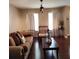 Comfortable living room showcasing a brown sofa with decorative pillows and hardwood flooring at 400 Antlers Ct, Gastonia, NC 28052