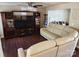 Inviting living room with dark hardwood floors, a large media center, and comfortable beige leather sofas at 400 Antlers Ct, Gastonia, NC 28052