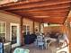 Inviting covered patio with wood ceiling, ceiling fans, comfortable seating, and a dining area for outdoor entertaining at 400 Antlers Ct, Gastonia, NC 28052