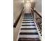 Carpeted staircase with wooden handrail and white risers leading to the upper level at 400 Antlers Ct, Gastonia, NC 28052