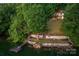 Serene backyard featuring a dock, waterfront access, and lush greenery at 4749 16Th Street Ne Dr, Hickory, NC 28601