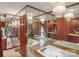 Bathroom with jetted tub surrounded by mirrored walls and paneled wood, beneath a chandelier at 4749 16Th Street Ne Dr, Hickory, NC 28601