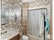 Bathroom featuring patterned wallpaper, a sink, a toilet, and a shower at 4749 16Th Street Ne Dr, Hickory, NC 28601