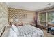 Cozy bedroom features vintage wallpaper, ample natural light, and traditional furnishings at 4749 16Th Street Ne Dr, Hickory, NC 28601